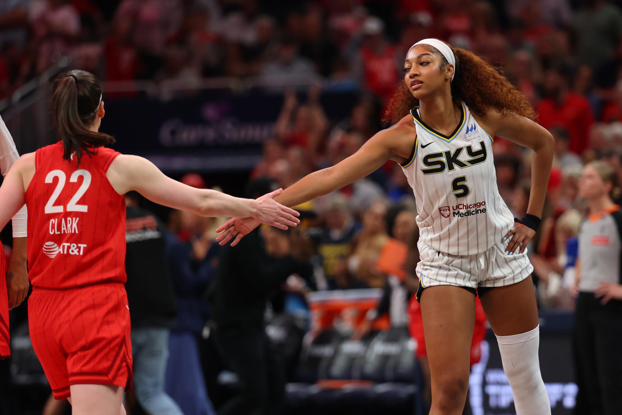 The Sky's Angel Reese and the Fever's Caitlin Clark shake hands before a game at Gainbridge Fieldhouse on May 17.