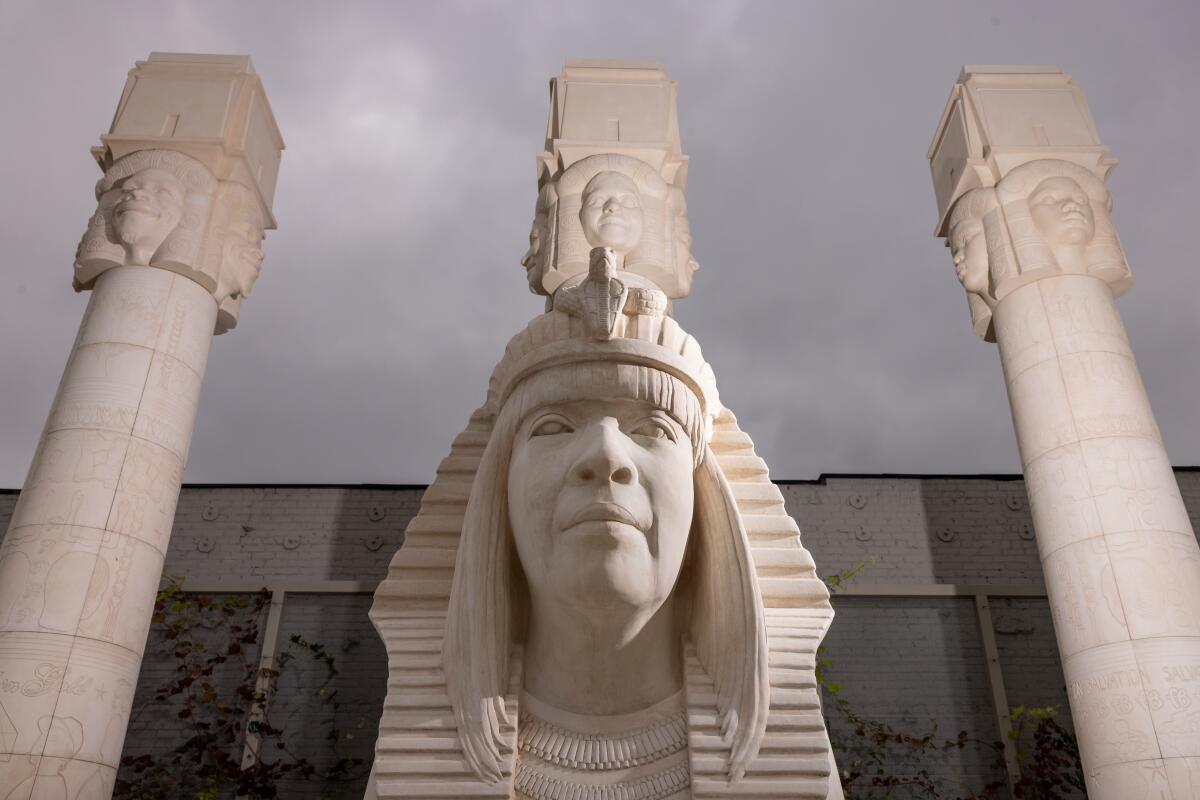 Sphinxes and carved reliefs alongside Egyptian-style Hathoric columns 