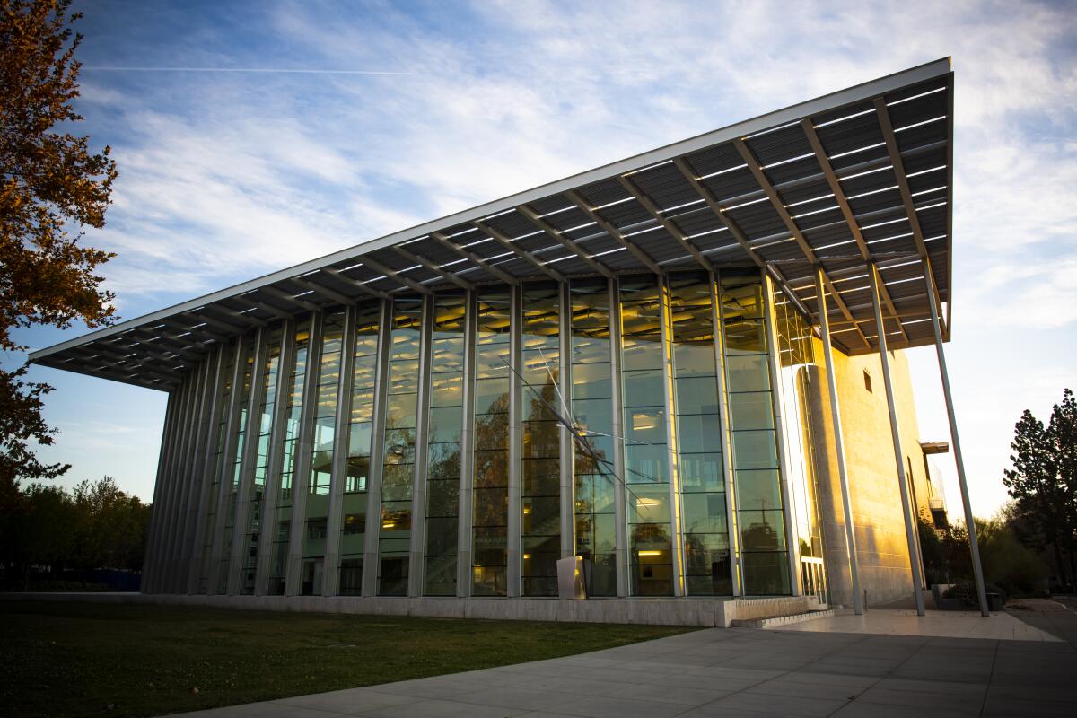 The exterior of a stone, tile and glass concert hall.