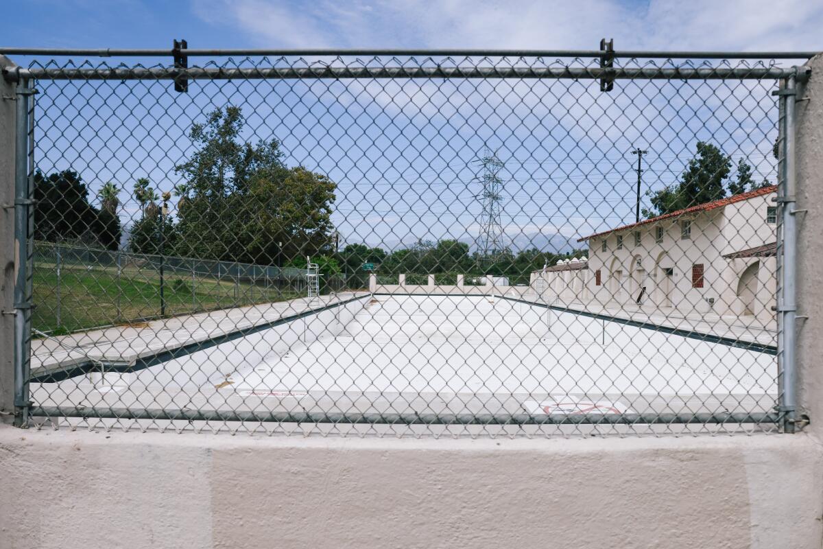The Griffith Park pool behind a chain-link fence and gate.