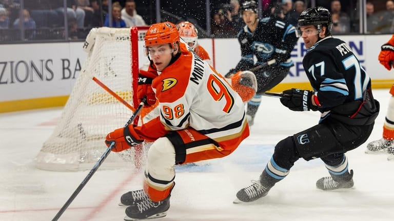 Anaheim Ducks defenseman Pavel Mintyukov (98) skates with the puck...