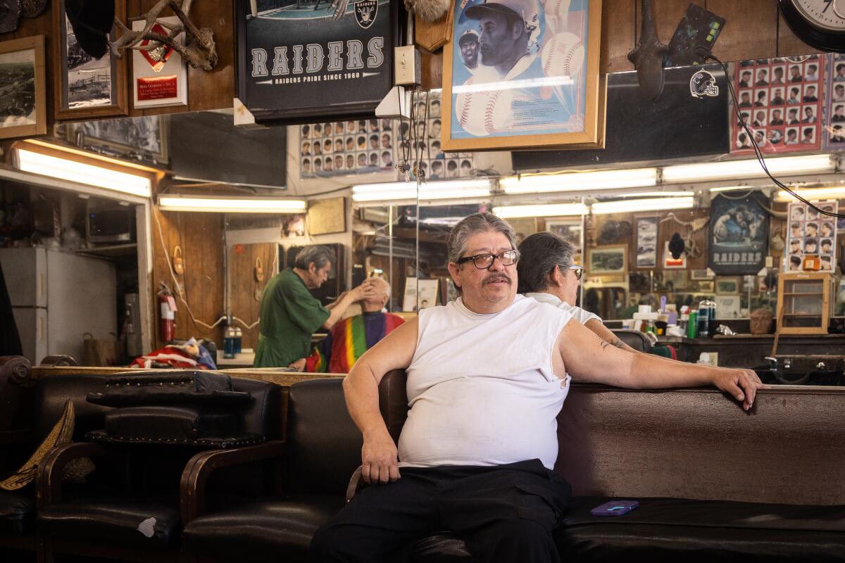 Rodney Trammell waits for his turn at a barbershop on Cesar E. Chavez Avenue.