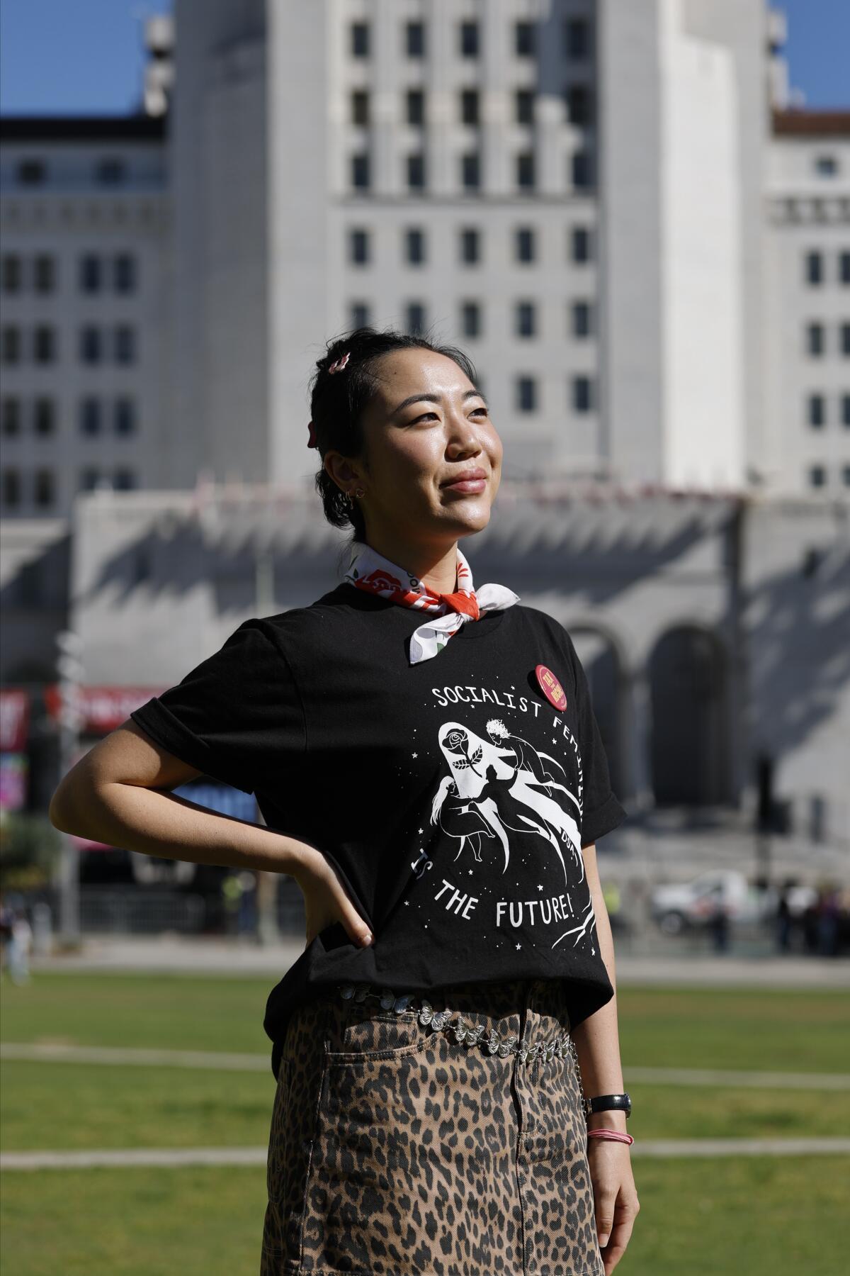 A woman poses for a portrait in front of Los Angeles City Hall.