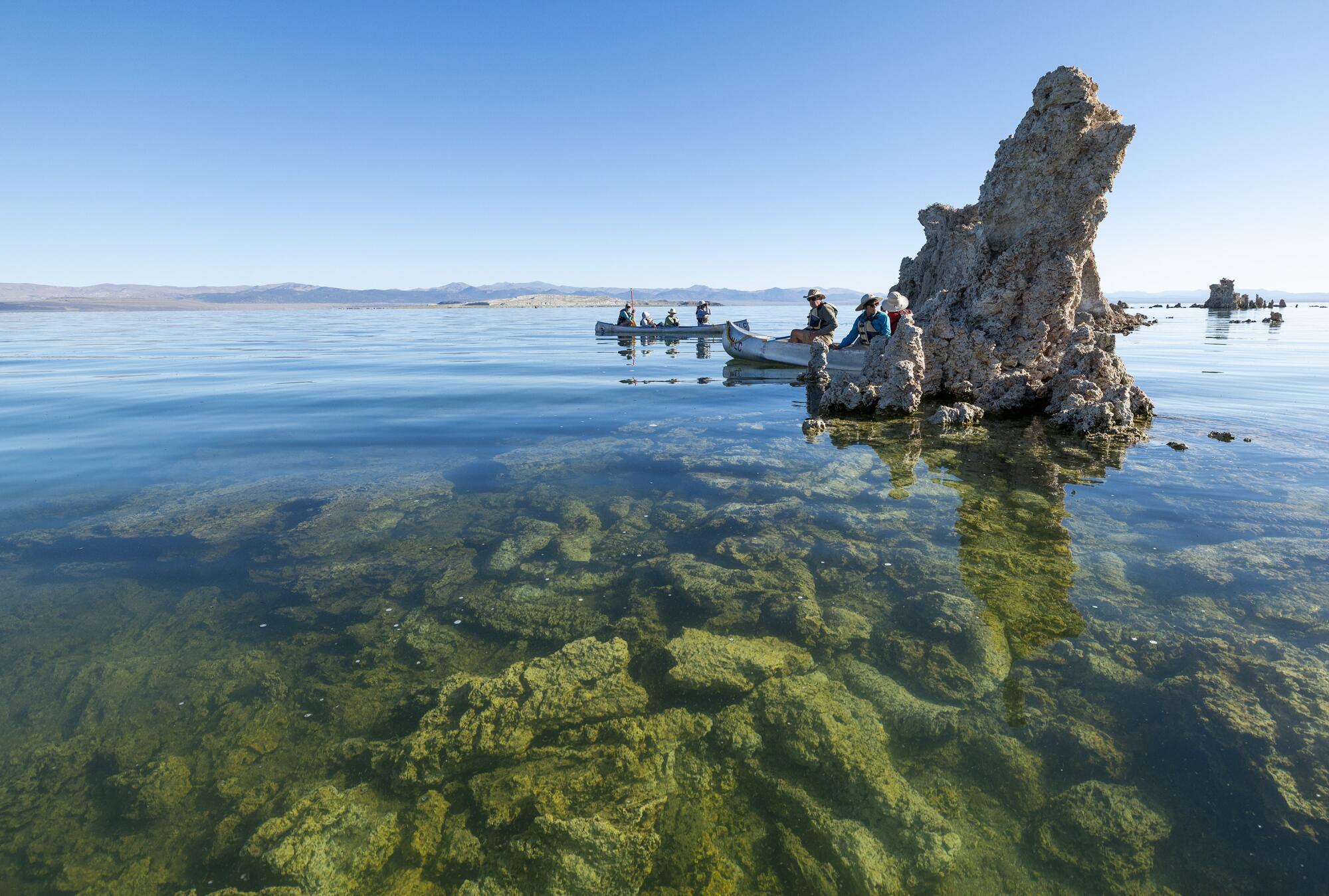 A canoe tour stops near a tufa.