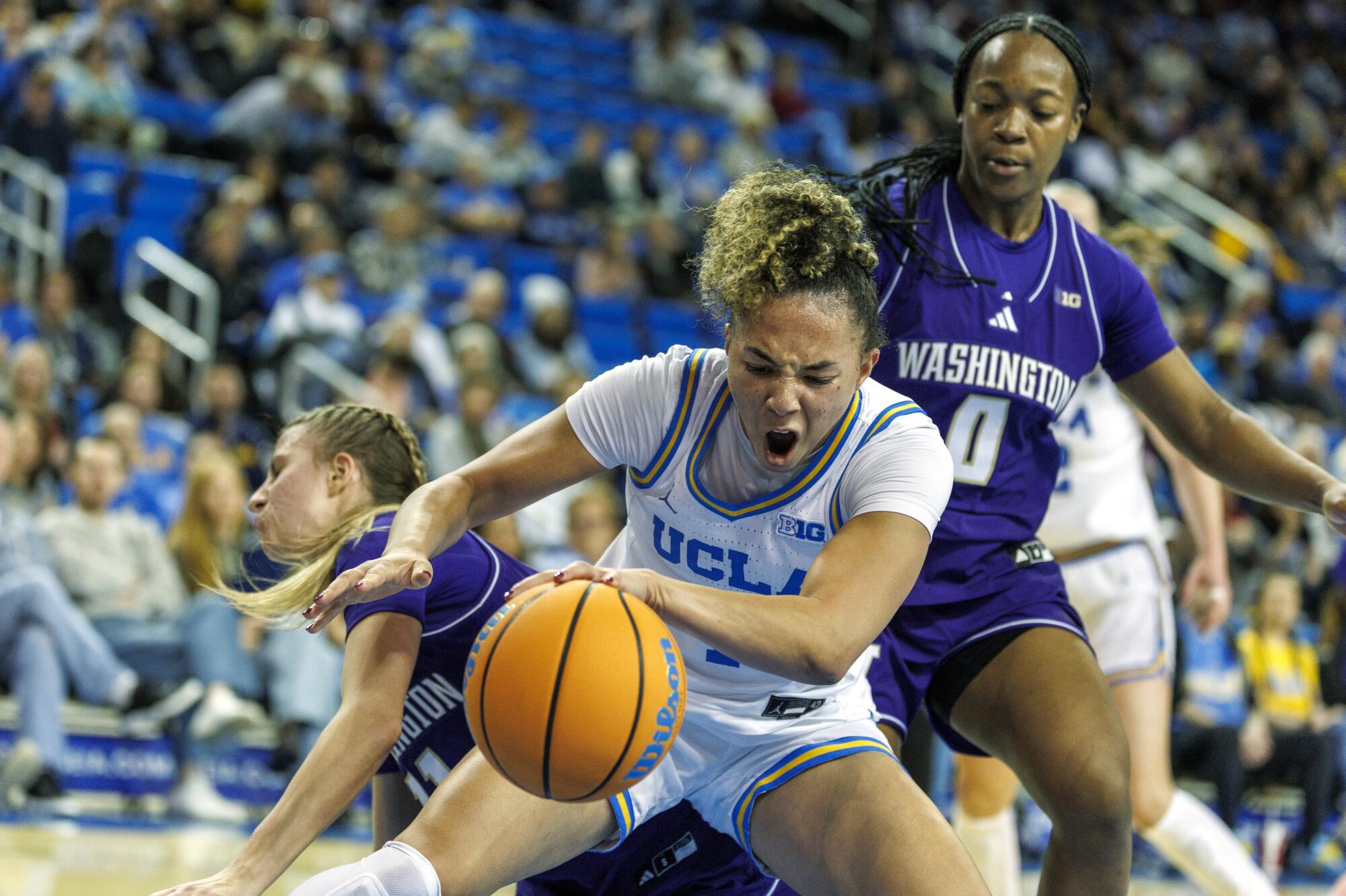 UCLA guard Kiki Rice steals the ball from Washington guard Chloe Briggs at Pauley Pavilion on Thursday night.