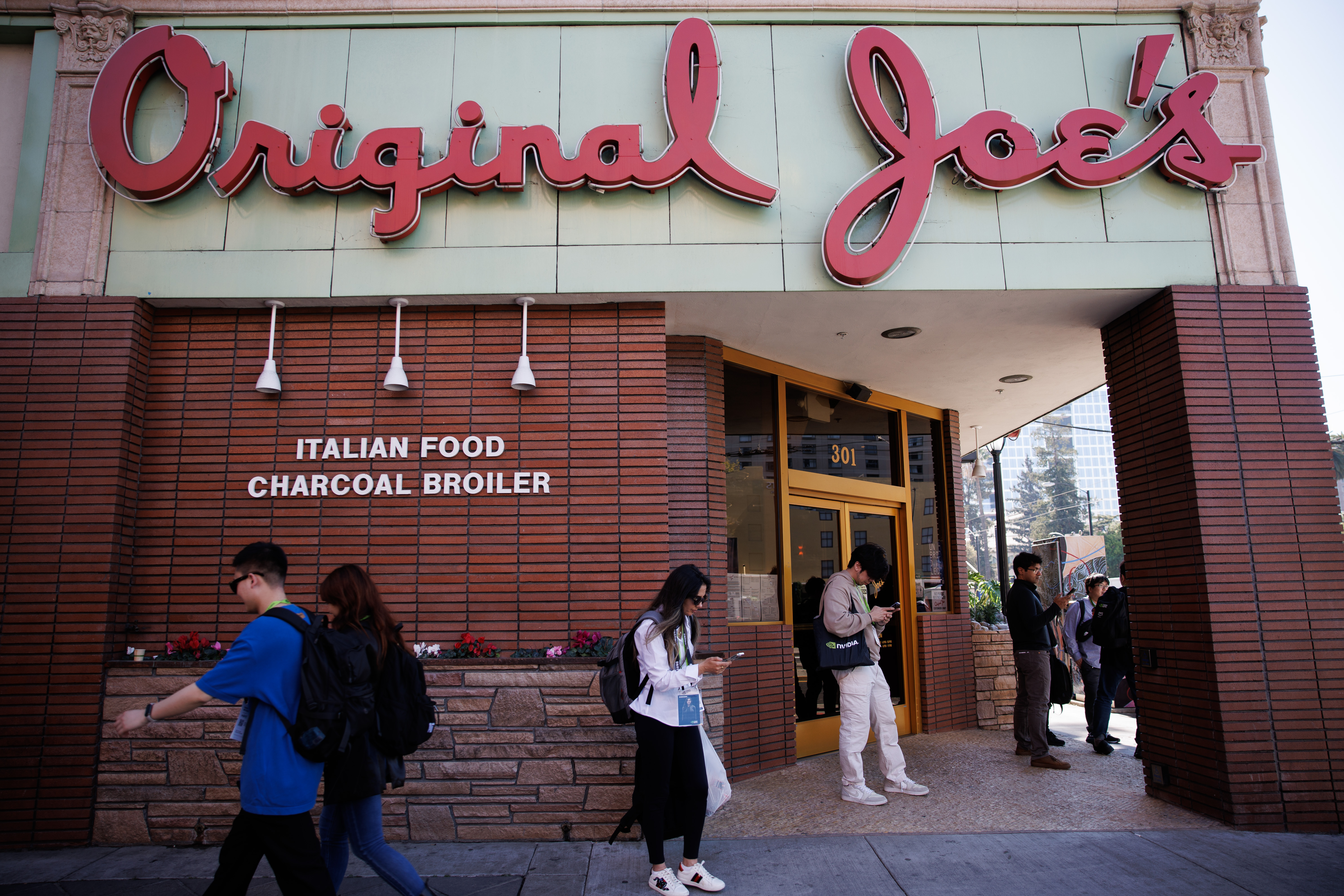 Attendees of the Nvidia GTC 2026 conference stand in front...