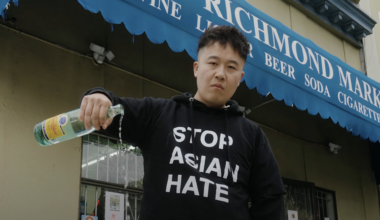 A man pours out liquor in front of Richmond Market.