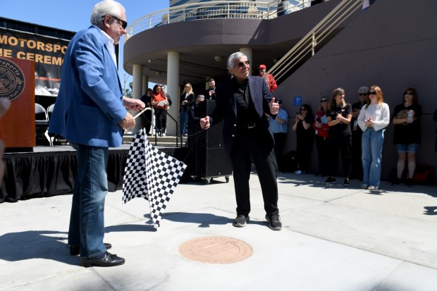 Jim Michaelian, right, is joined by Chris Pook, originator of the Grand Prix of Long Beach, during Michaelian's induction ceremony in the Motorsports Walk of Fame at the Long Beach Convention Center on Thursday, April 10, 2025. (Photo by Axel Koester, Contributing Photographer)