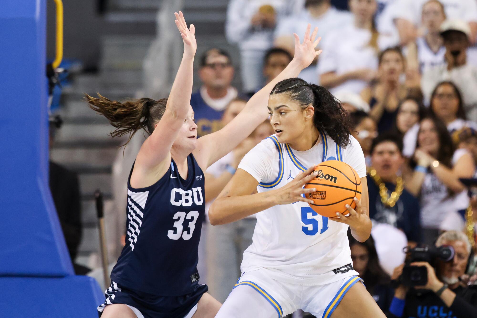 UCLA center Lauren Betts drives against California Baptist forward Grace Schmidt in the first half Saturday.