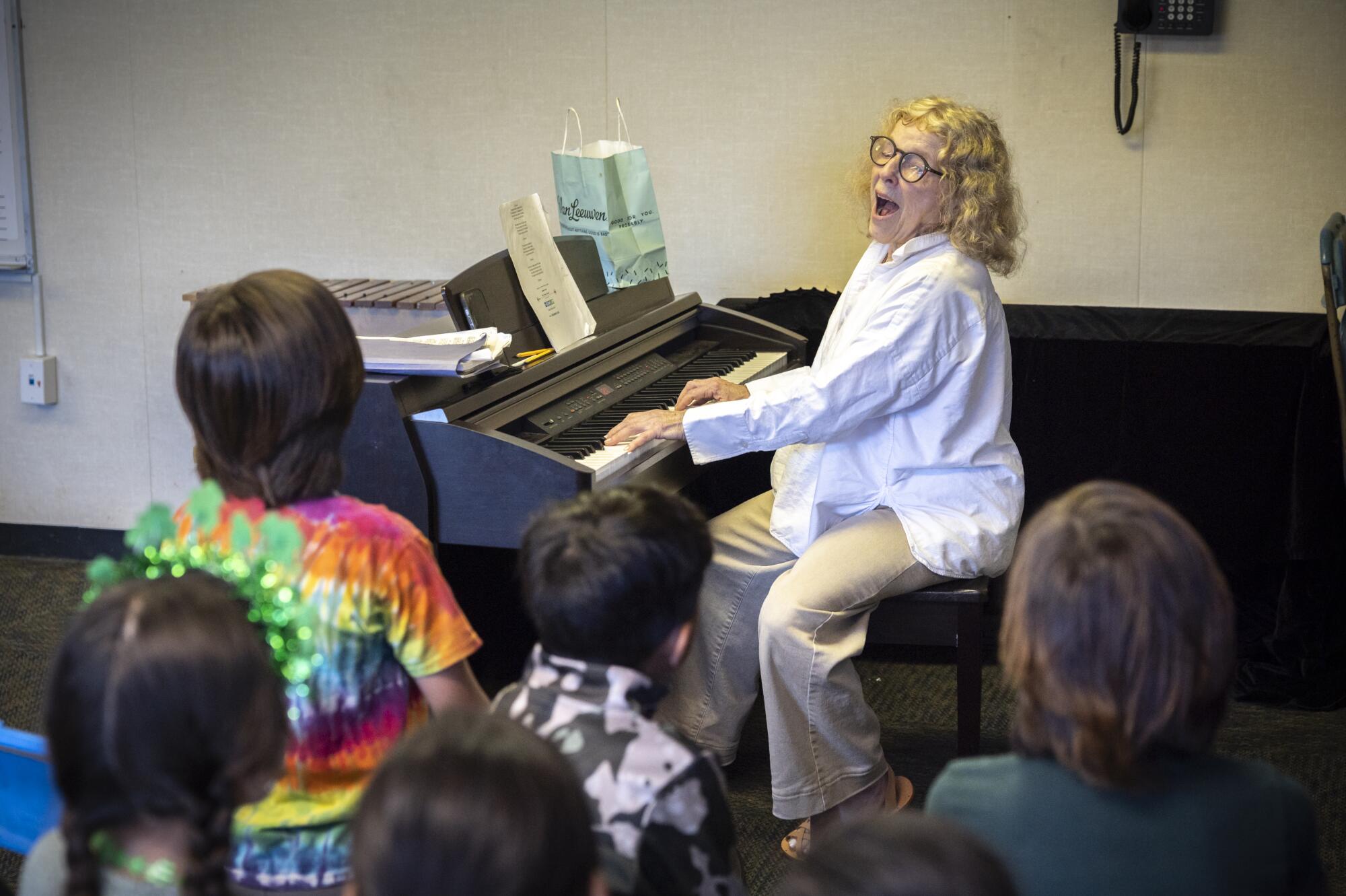 Music teacher Mary Ann Cummins works with second-graders at St. Anne's Elementary School.