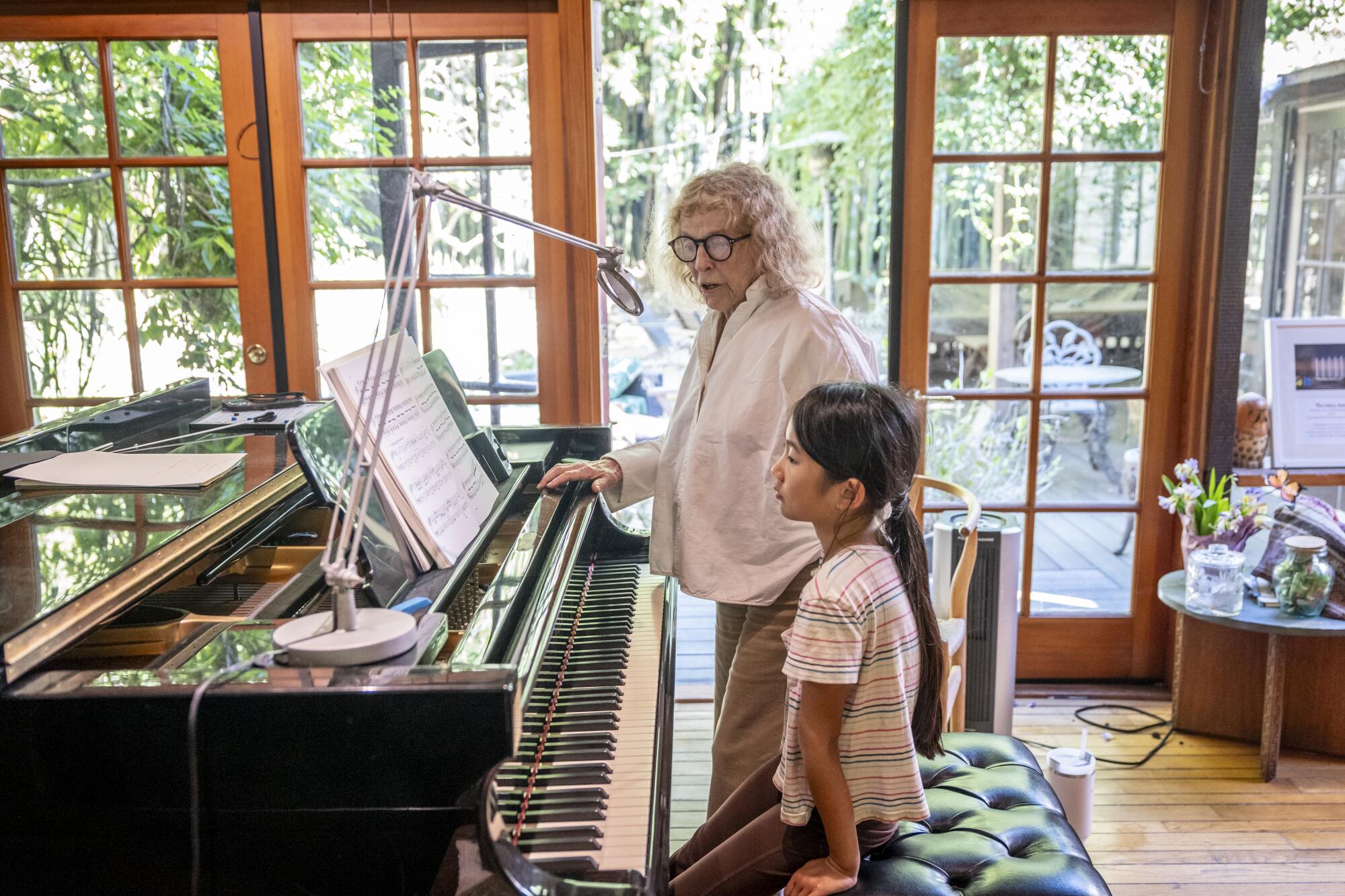 Mary Ann Cummins works with student Cara Cheng at Cummins' home.