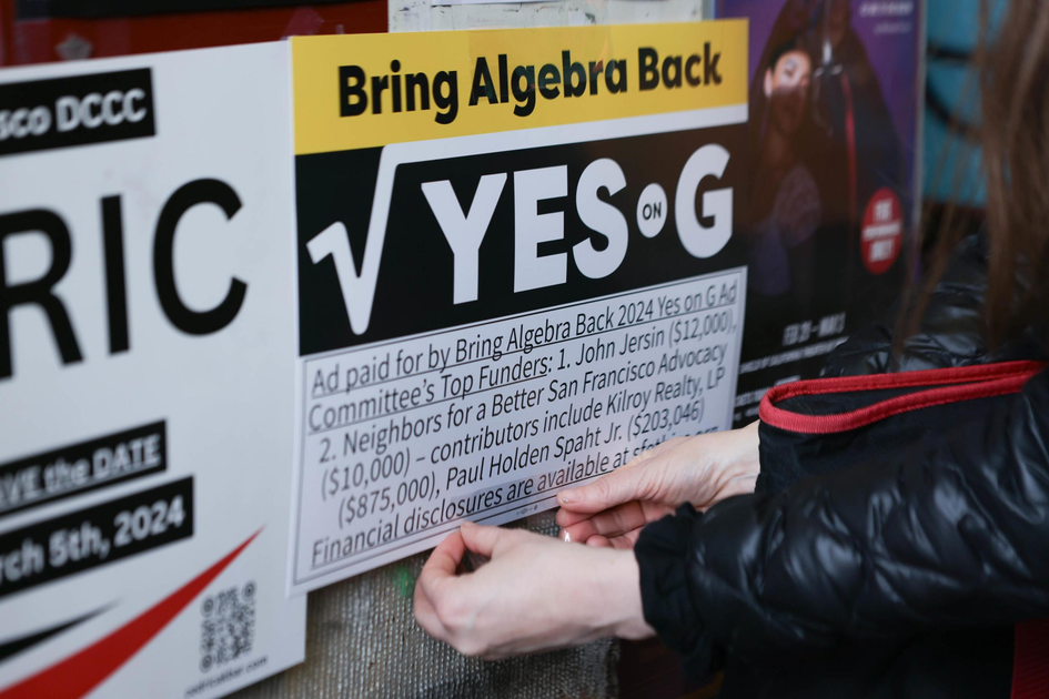 A person is putting up a "Bring Algebra Back YES on G" sign with funding details below it.
