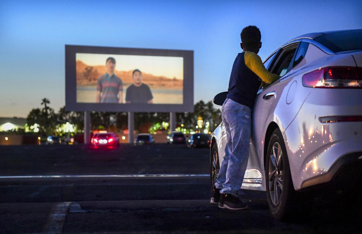 Michael Ray, 11, watches a trailer before a movie at the Paramount Drive-In.