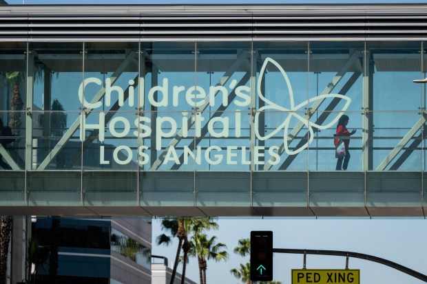 A person uses Children's Hospital Los Angeles' bridge over Sunset Boulevard on Friday, March 20, 2026. California hospitals including Children's Hospital are facing healthcare cuts in the form of layoffs as a result of the "One Big Beautiful Bill Act." (Photo by Sarah Reingewirtz, Los Angeles Daily News/SCNG)