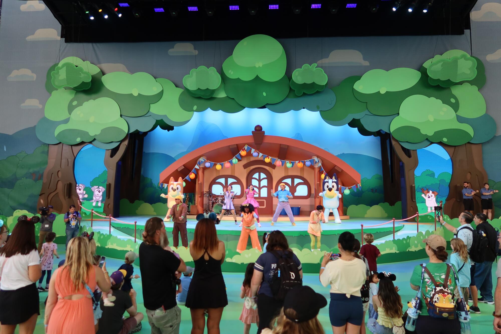 People watch "Bluey's Best Day Ever!" cast on a theater stage.