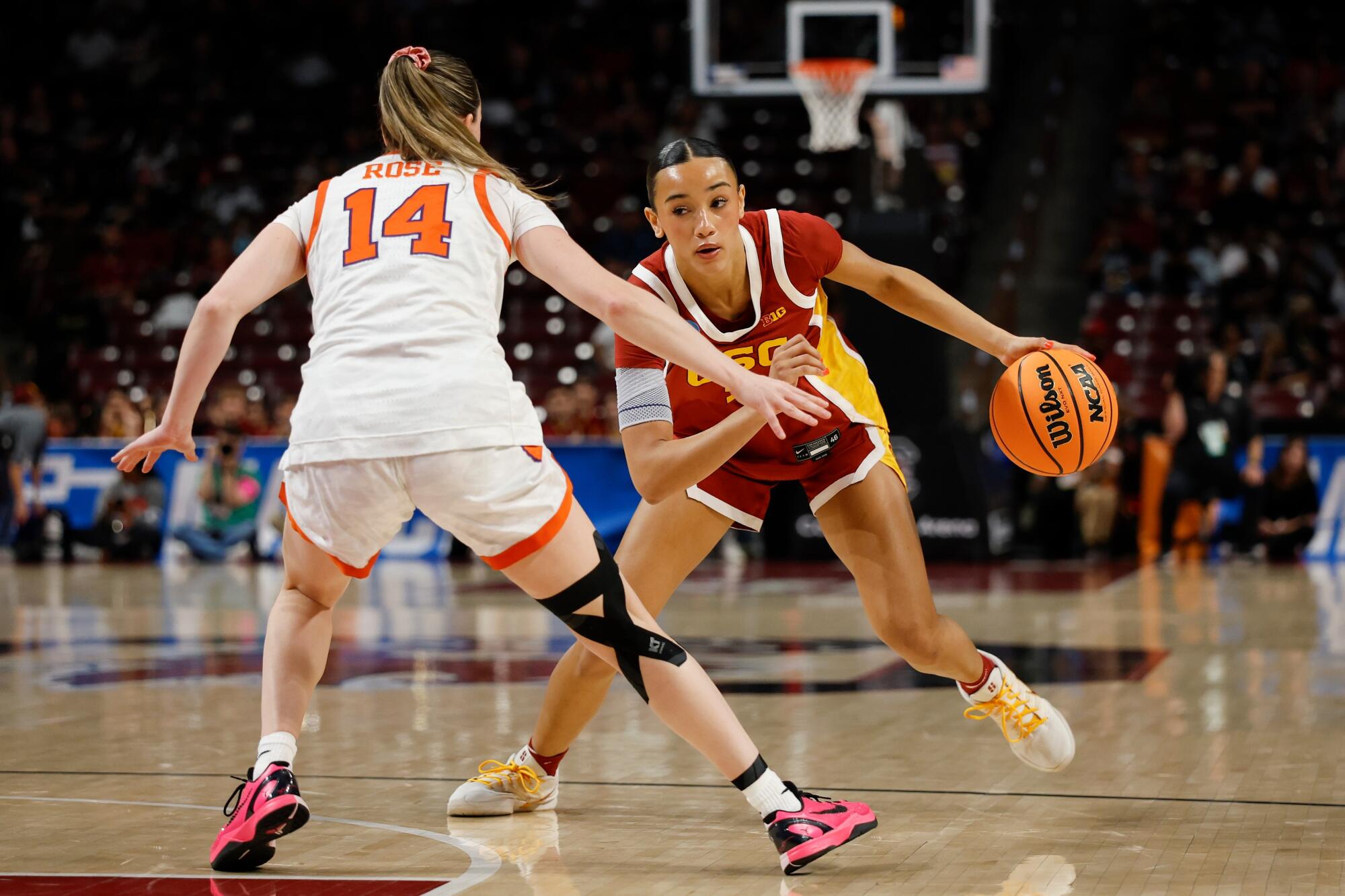 USC guard Jazzy Davidson drives under pressure from Clemson guard Rachael Rose.