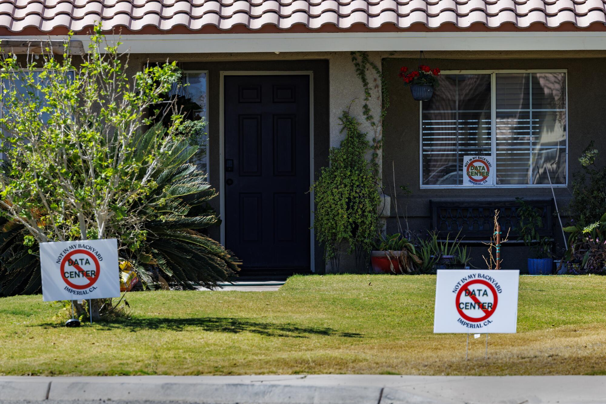 No Data Center signs are posted in the front yard of a home.