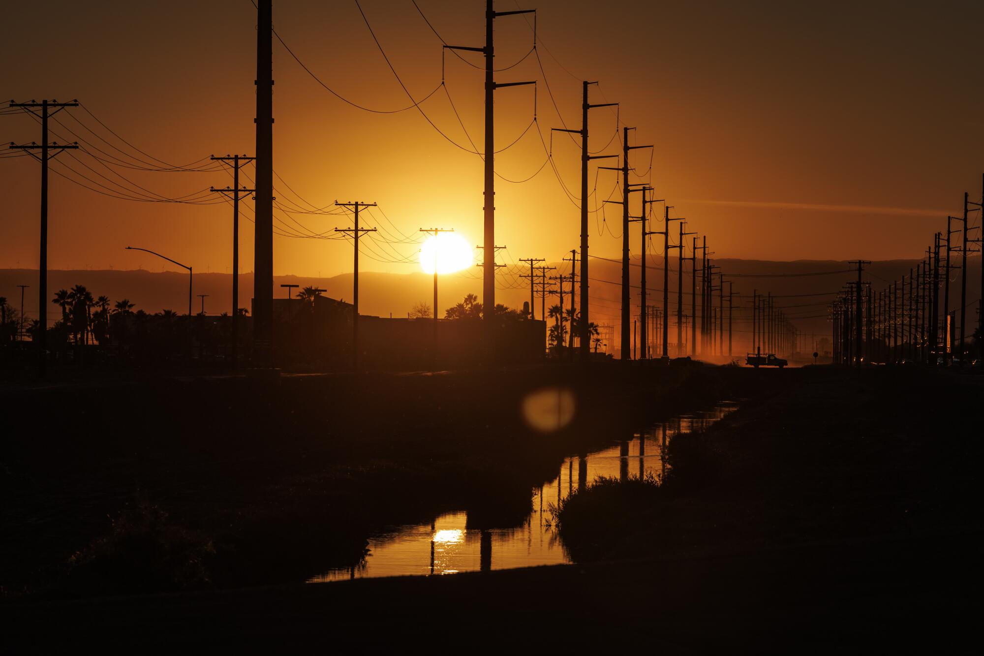 A dusty haze settles over the city of Imperial at dusk near the site of a proposed data center.