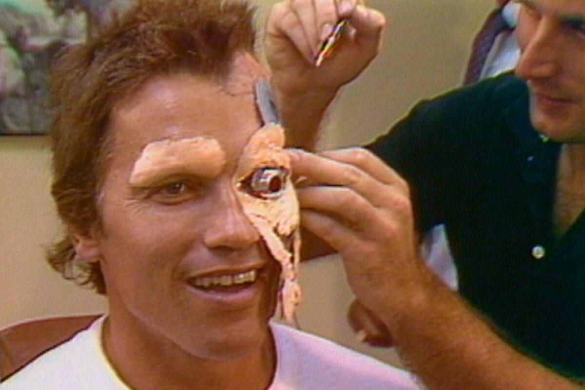 A makeup artist applying Arnold Schwarzenegger's "Terminator" prosthetics.