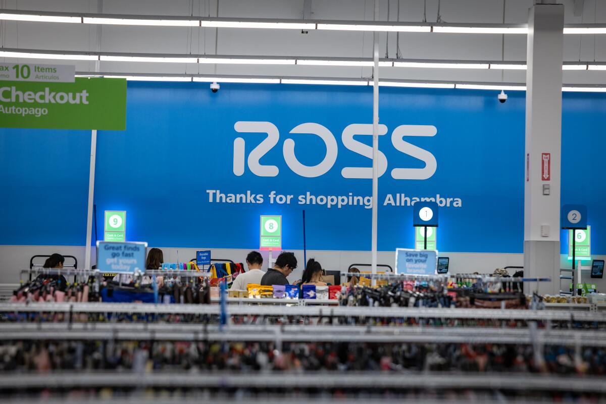People check out after shopping at a newly opened Ross store.