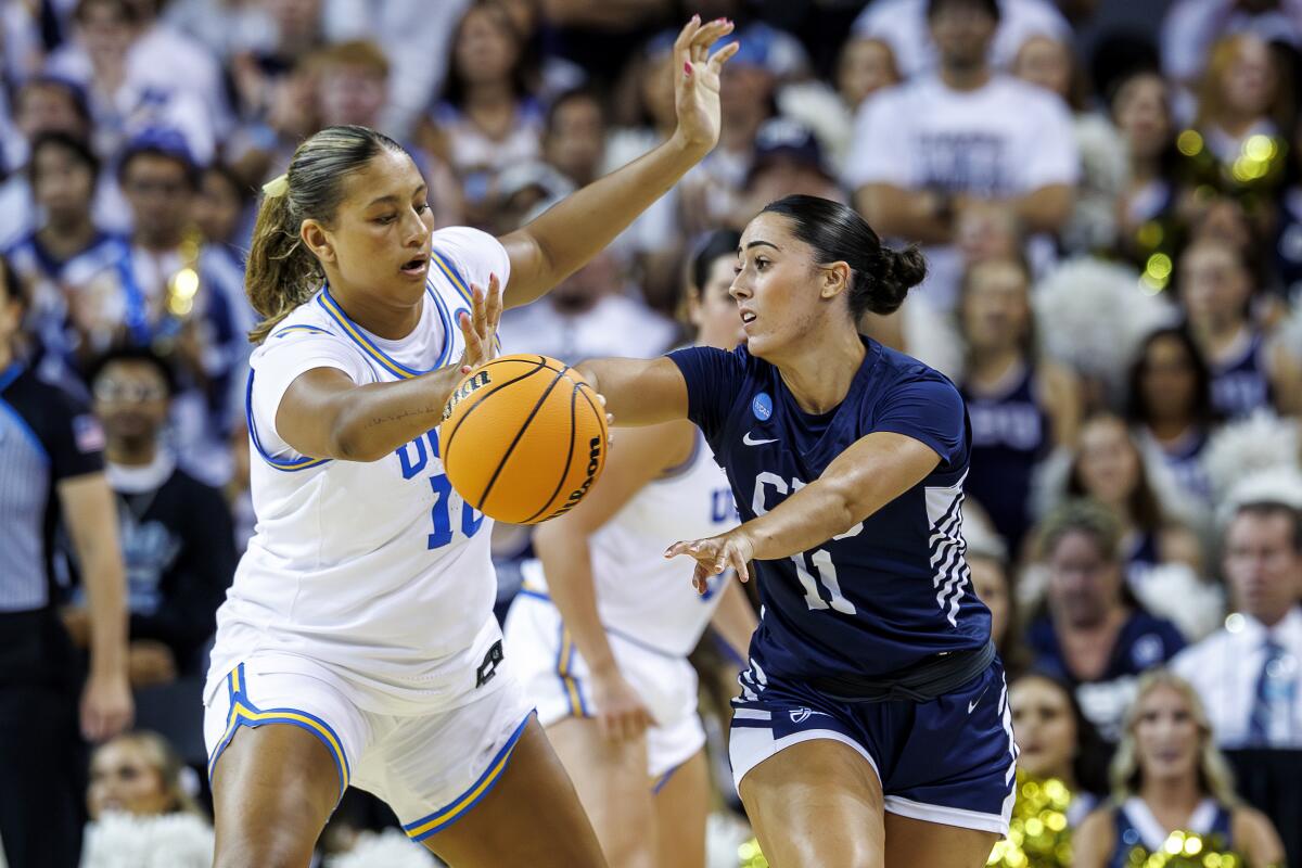 UCLA freshman forward Sienna Betts plays tight defense on California Baptist guard Sofia Alonso.