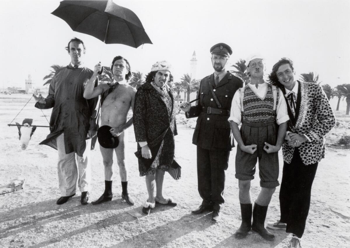 Cast members of the original "Monty Python's Flying Circus" line up on a beach