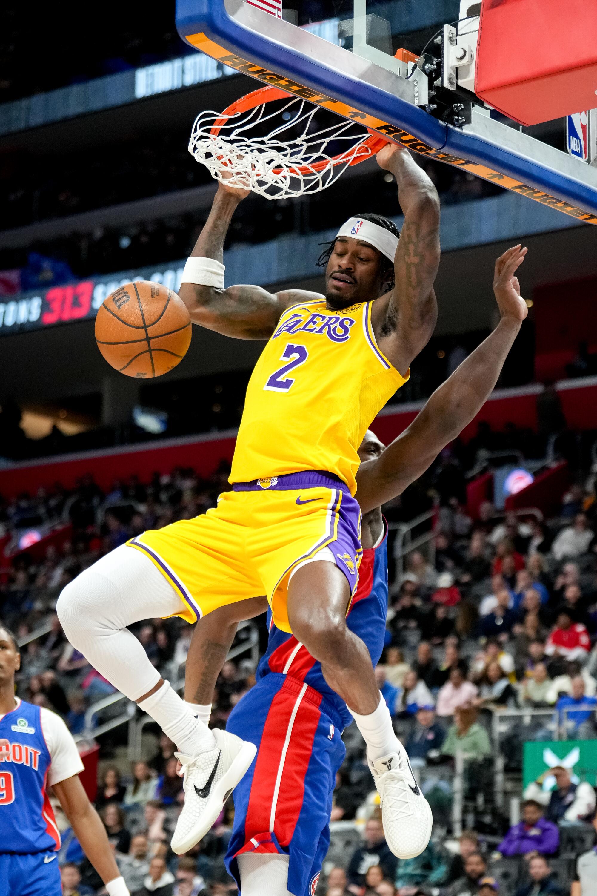 Lakers forward Jarred Vanderbilt dunks over Detroit's Jalen Duren in the first half Monday.