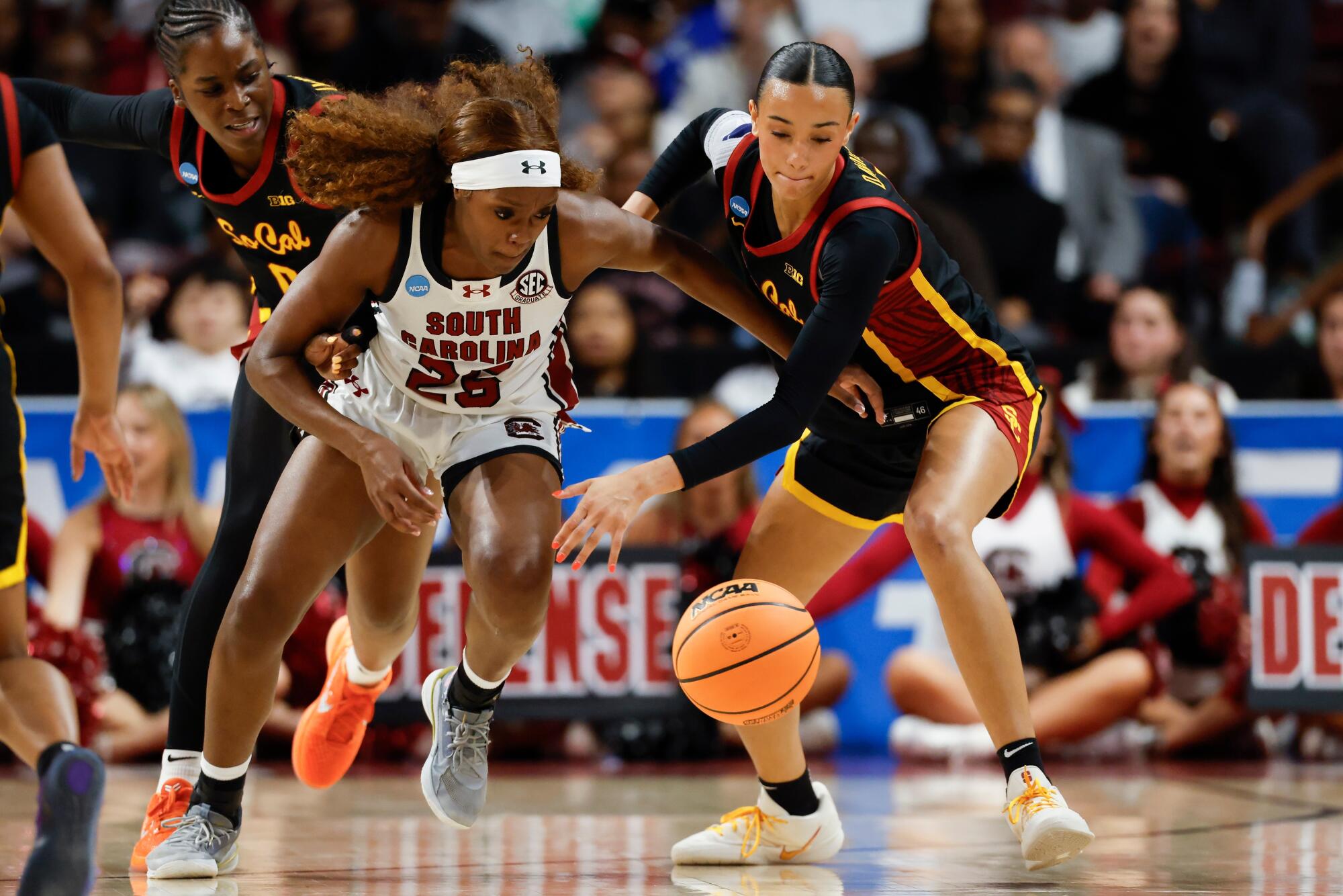 USC guard Jazzy Davidson battles South Carolina guard Raven Johnson for a loose ball.
