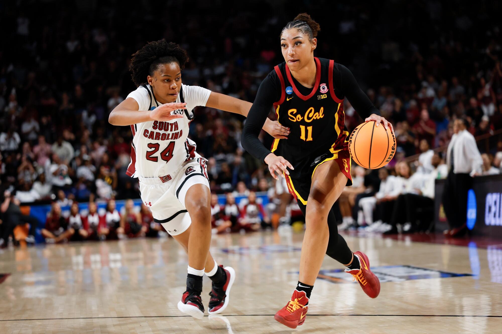 USC guard Kennedy Smith drives under pressure from South Carolina guard Ayla McDowell Monday in Columbia, S.C. 