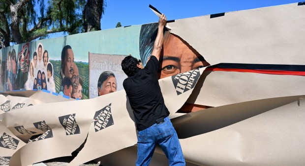 The murals and statue of Cesar E. Chavez at the memorial park in the City of San Fernando were covered on Thursday morning, March 19, 2026. In the early afternoon a man who called himself "Jose" removed the tape and covering from both the statue and the murals. (Photo by Dean Musgrove, Los Angeles Daily News/SCNG)