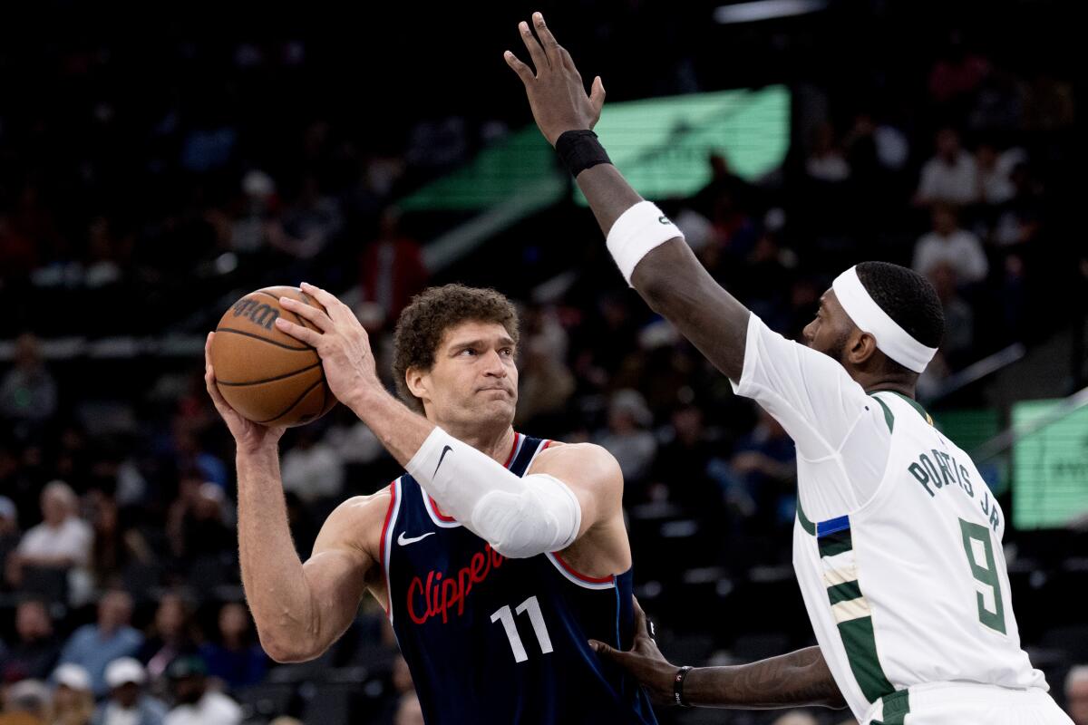 Brook Lopez looks to pass against Bucks forward Bobby Portis in the second half.