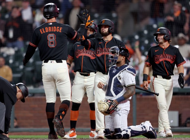San Francisco Giants' Bryce Eldridge #8 is congratulated by teammates after hitting a three-run home run in the eighth inning of their MLB game against the Sultanes de Monterrey at Oracle Park in San Francisco, Calif., on Monday, March 23, 2026. (Jane Tyska/Bay Area News Group)