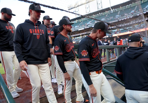San Francisco Giants players enter the dugout before their MLB game against the Sultanes de Monterrey at Oracle Park in San Francisco, Calif., on Monday, March 23, 2026. (Jane Tyska/Bay Area News Group)