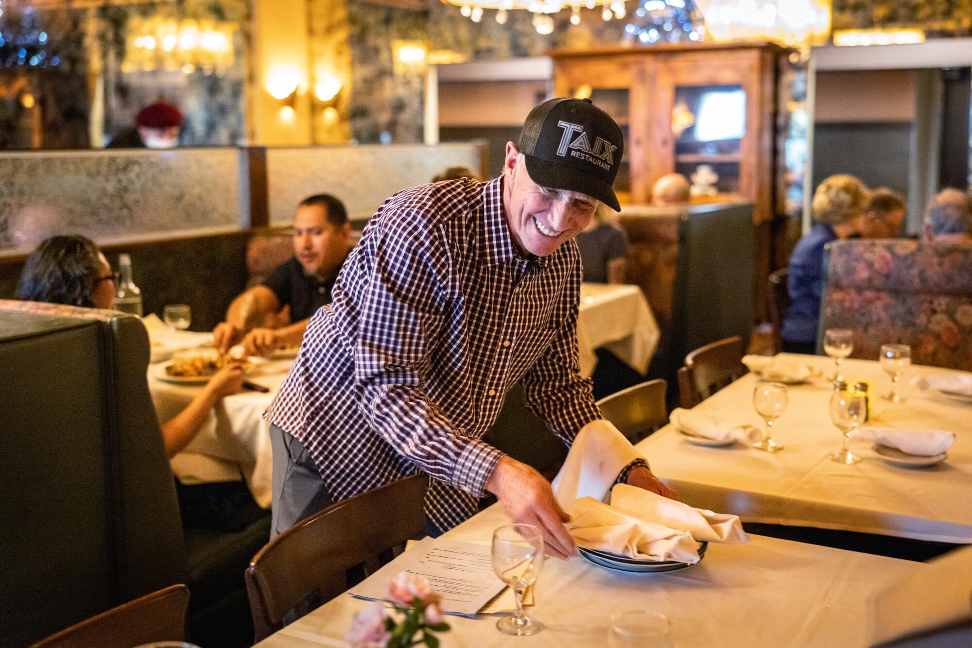 Michael Taix, the owner of the Echo Park French restaurant Taix, welcomes guests after ushering them to their seats