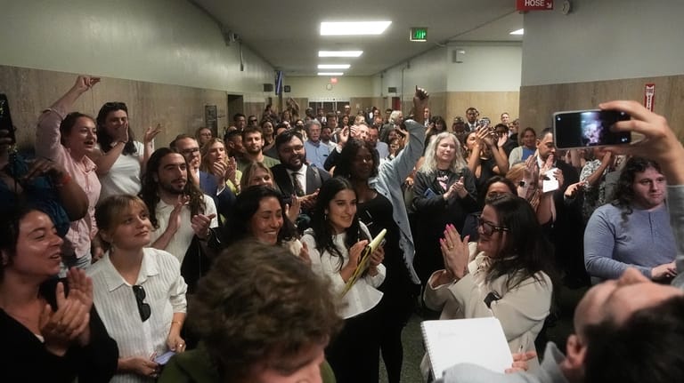 Supporters of San Francisco Public Defender Mano Raju cheer outside...