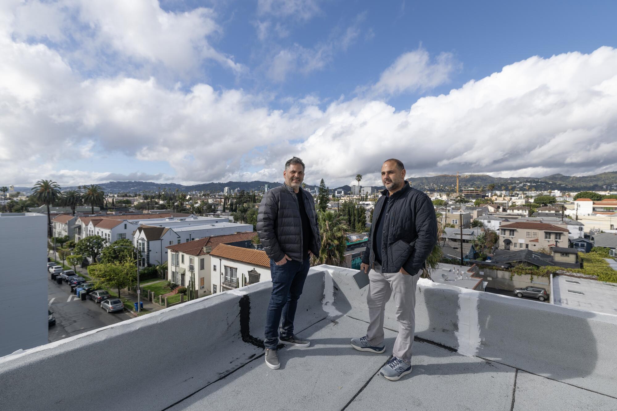 Two men on the roof of a building.