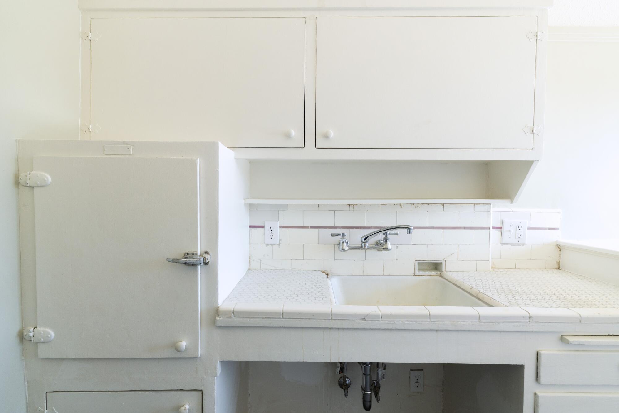 A historic kitchen with an icebox.