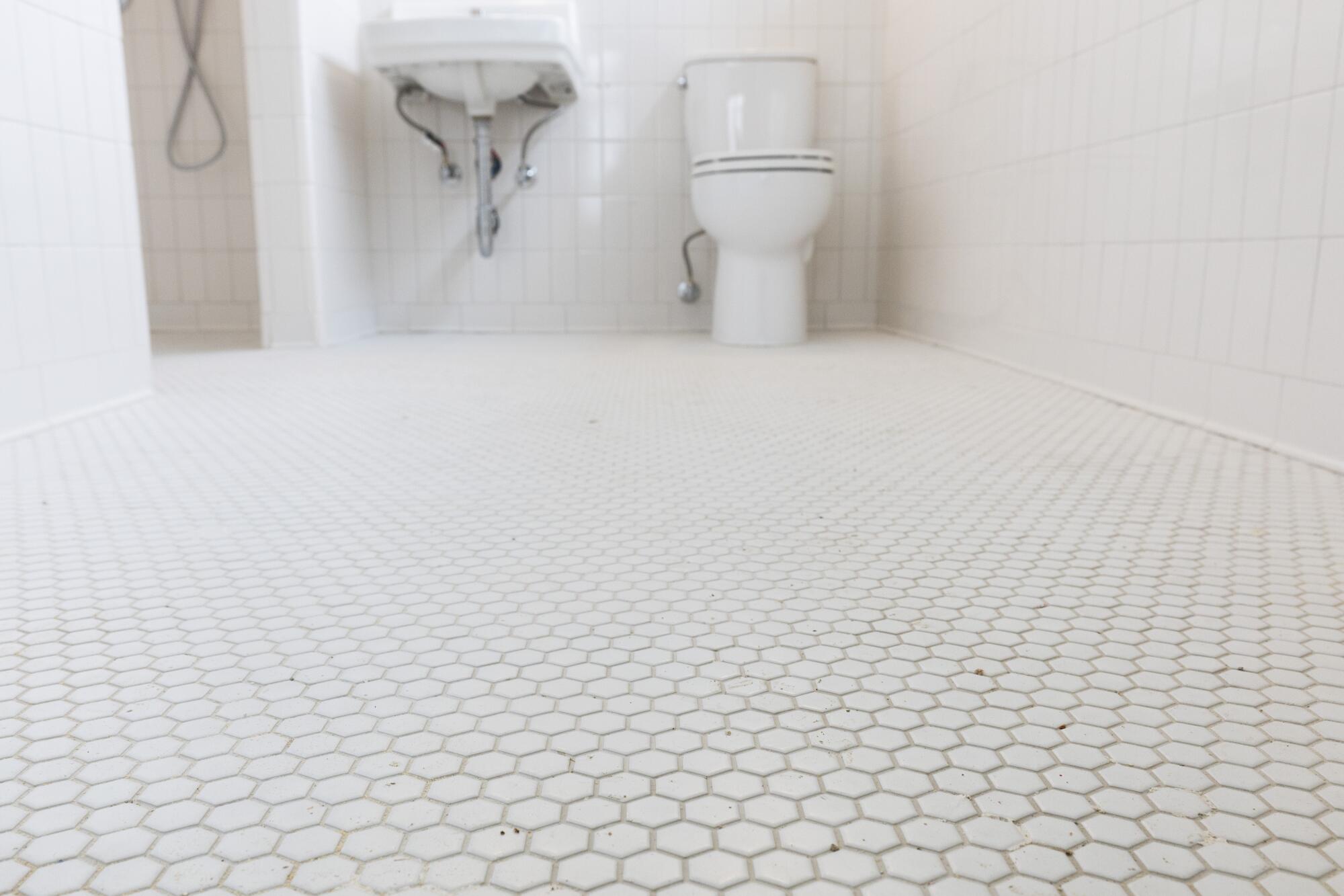 White tiles in an old-fashioned bathroom.