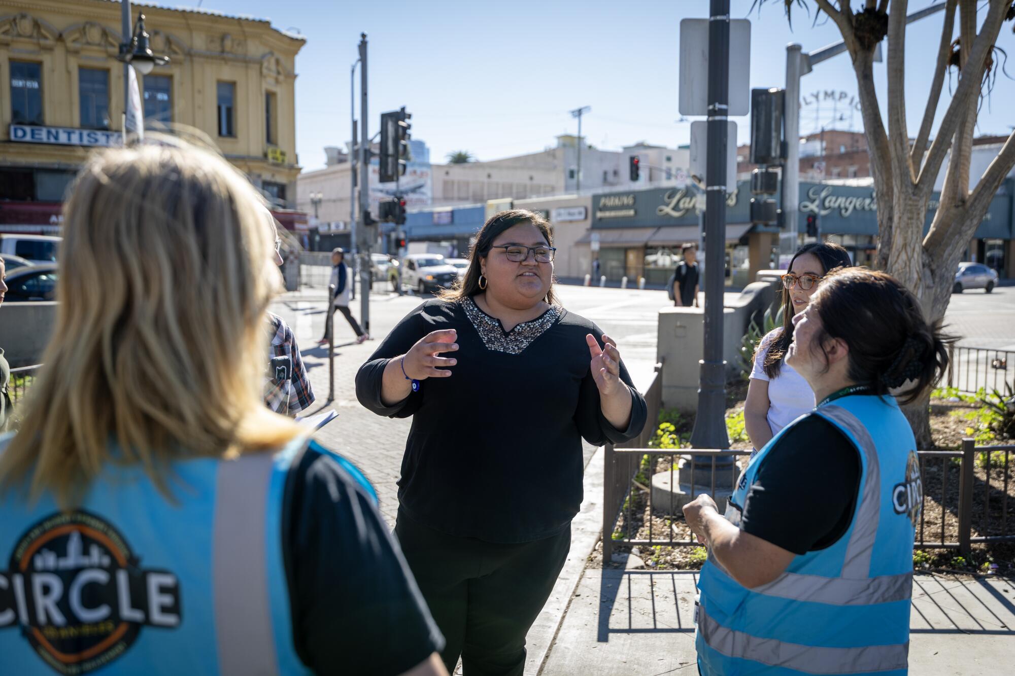 City Council member Eunisses Hernandez, center, talks with Circle outreach workers a homelessness response team.