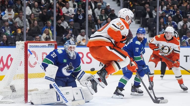 Vancouver Canucks goalie Kevin Lankinen (32) makes the save as...
