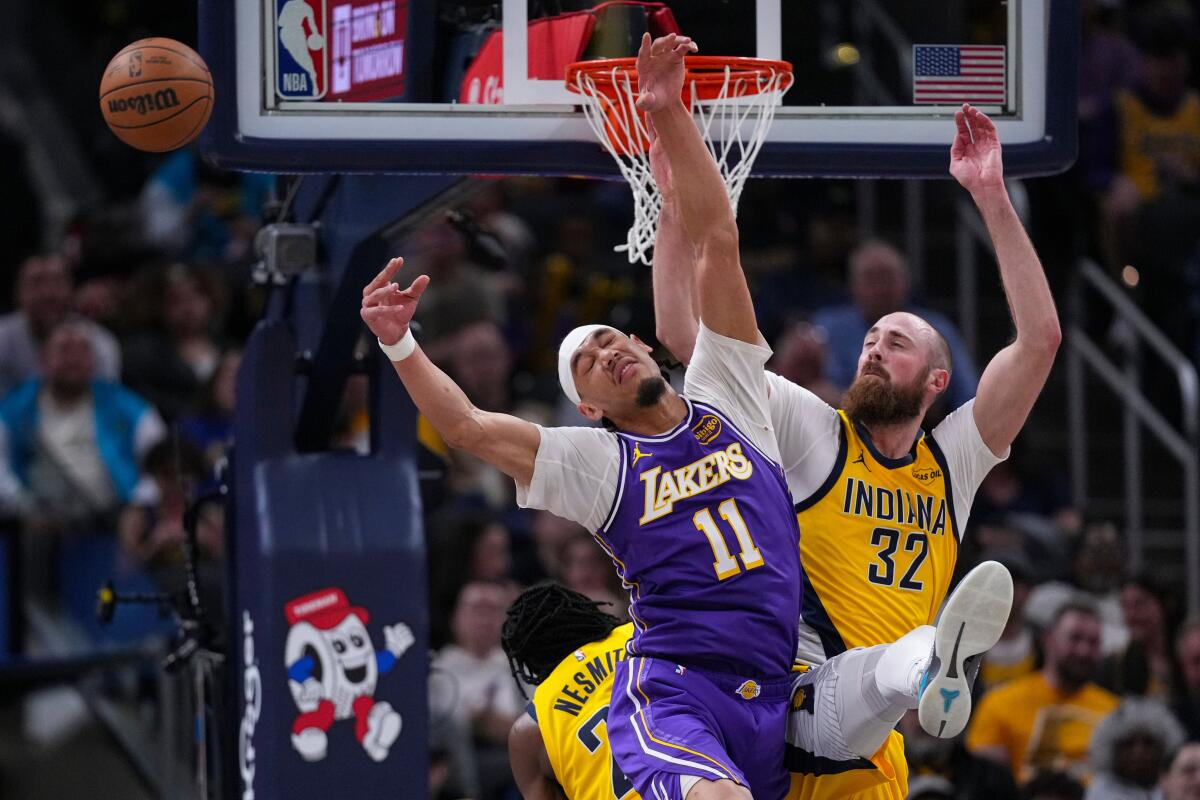Lakers center Jaxson Hayes, left, and Pacers center Jay Huff reach for a rebound.