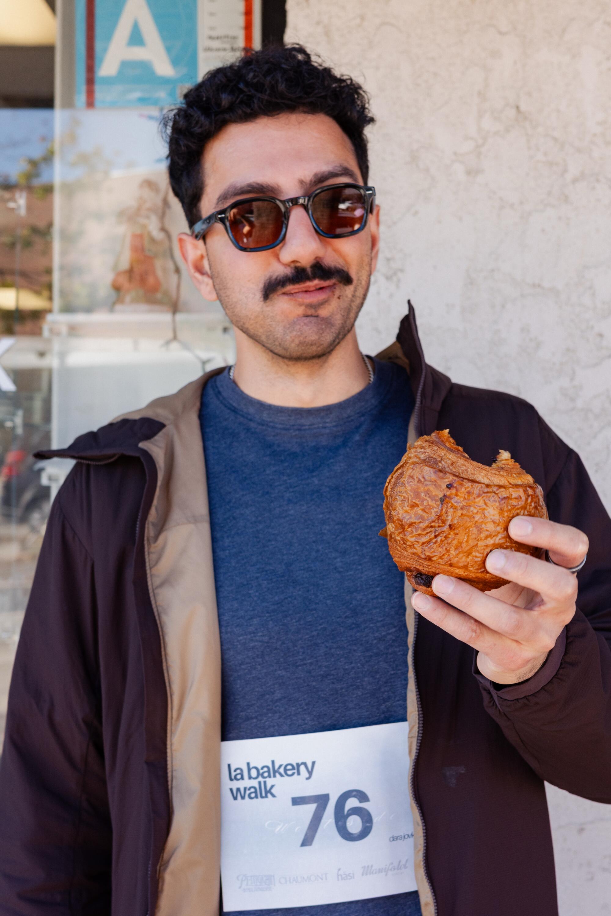 A marathon walker enjoys a chocolate croissant.