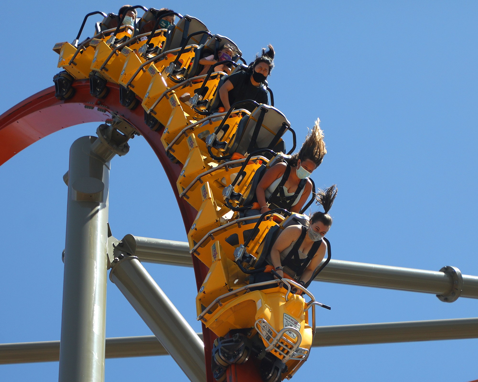 Guests ride the Rail Blazer roller coaster at California’s Great...