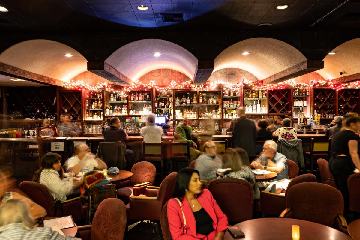 People fill the bar at a restaurant 