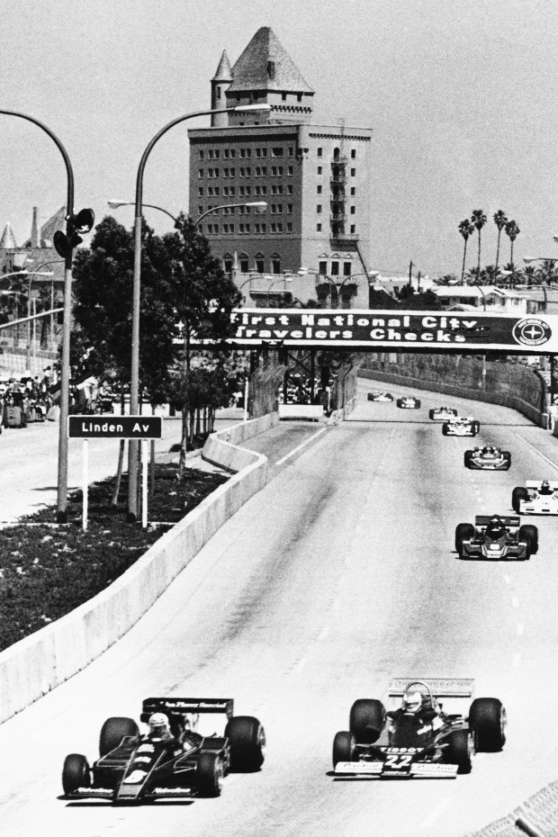Formula One drivers Mario Andretti, left, and Clay Regazzoni of Switzerland lead the field through the streets of Long Beach, Calif., during the early laps of the Long Beach Grand Prix, in this April, 3, 1977, file photo.The city closed its downtown streets for the first time in 1975 to host a street race that became one of the most prestigious events in  (AP Photo/File)