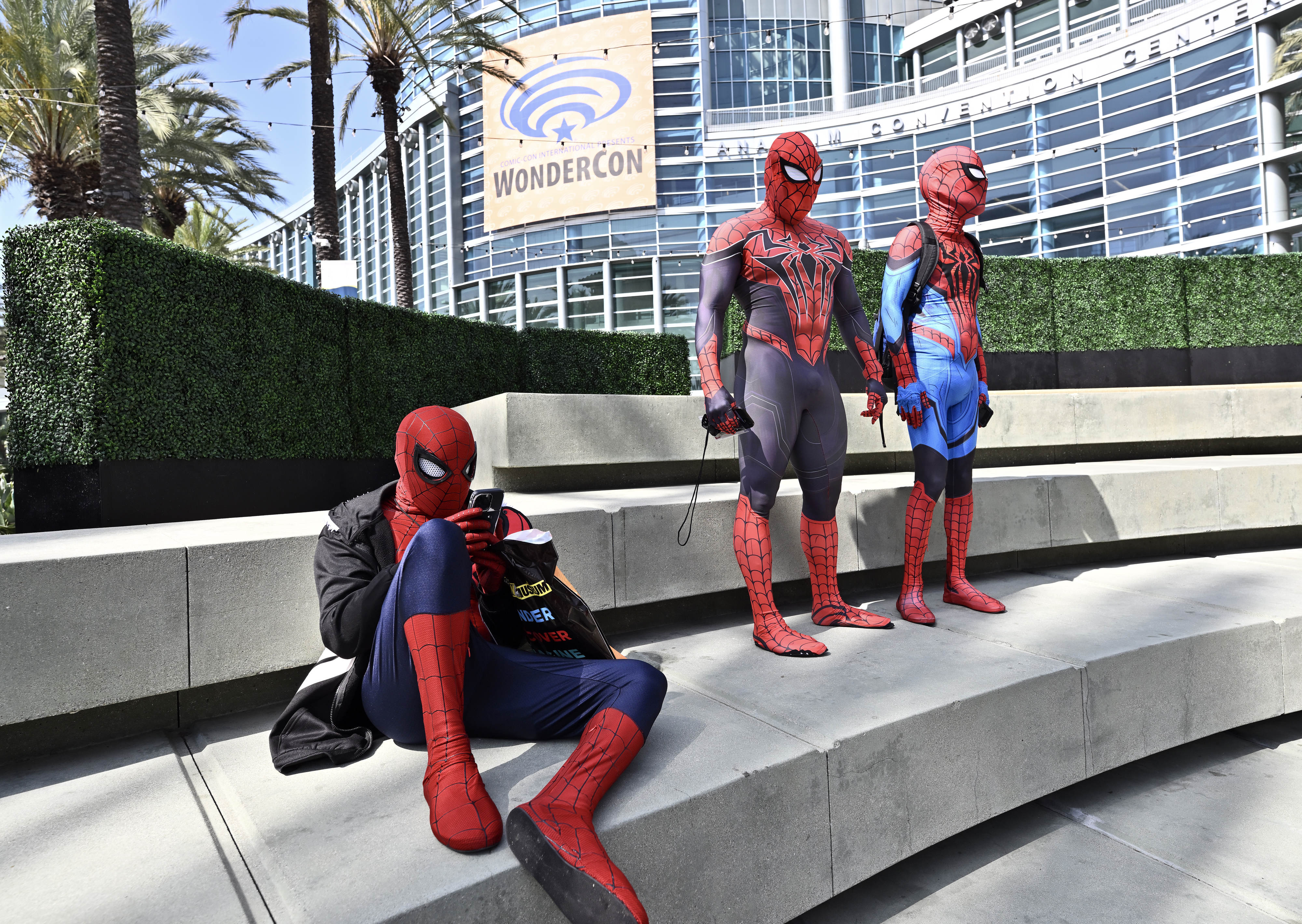 Spider-Men hang out as they wait for a photo meetup...