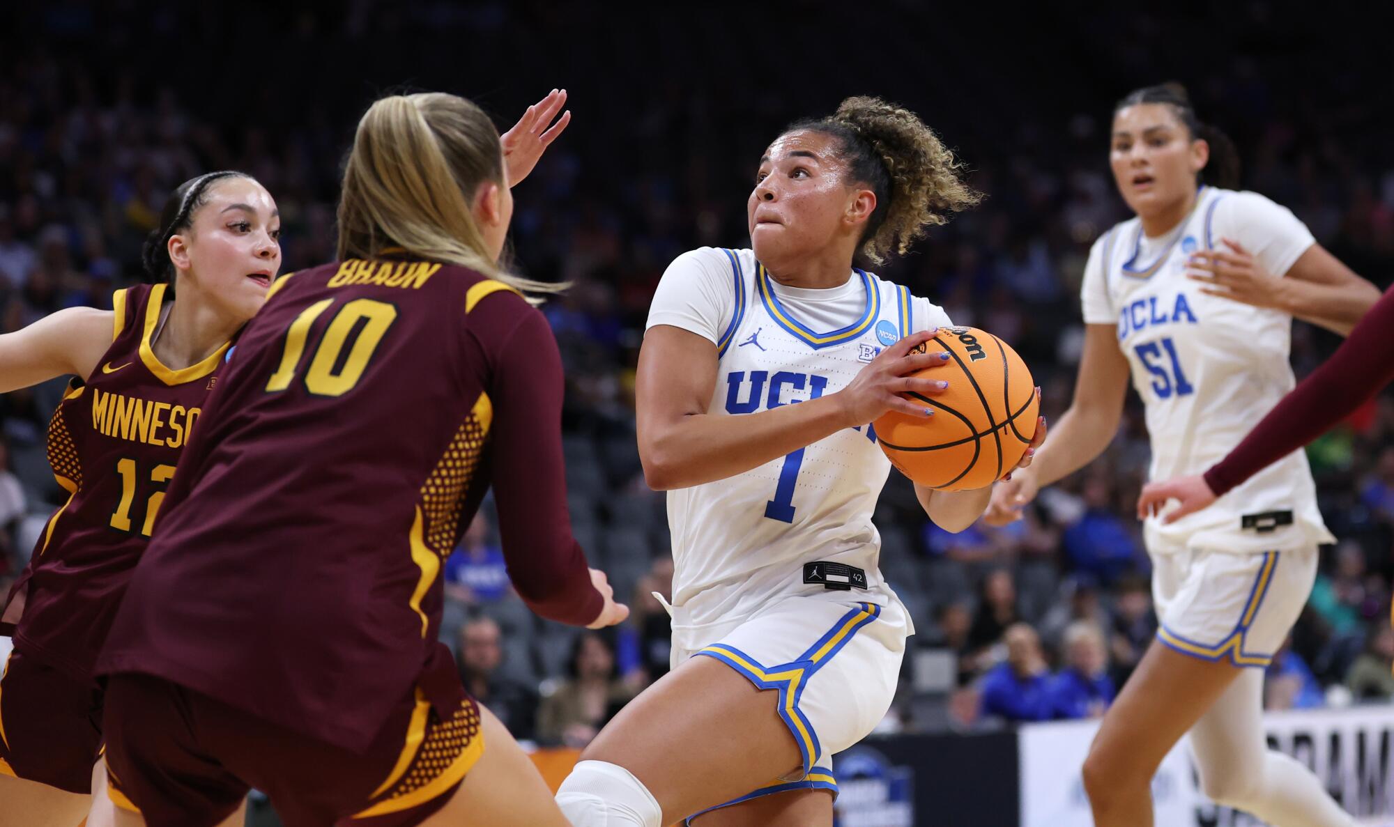 UCLA's Kiki Rice drives to the basket in front of Minnesota's Brylee Glenn, far left, and Mara Braun.
