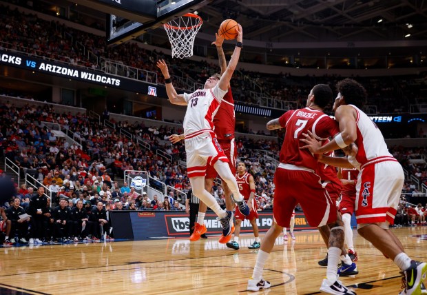 Arizona Wildcats' Motiejus Krivas (13) takes a shot against Arkansas Razorbacks' Malique Ewin (12) in the second half at the 2026 NCAA Division I West Regional Semifinal game at the SAP Center in San Jose, Calif., on Thursday, March 26, 2026. (Nhat V. Meyer/Bay Area News Group)