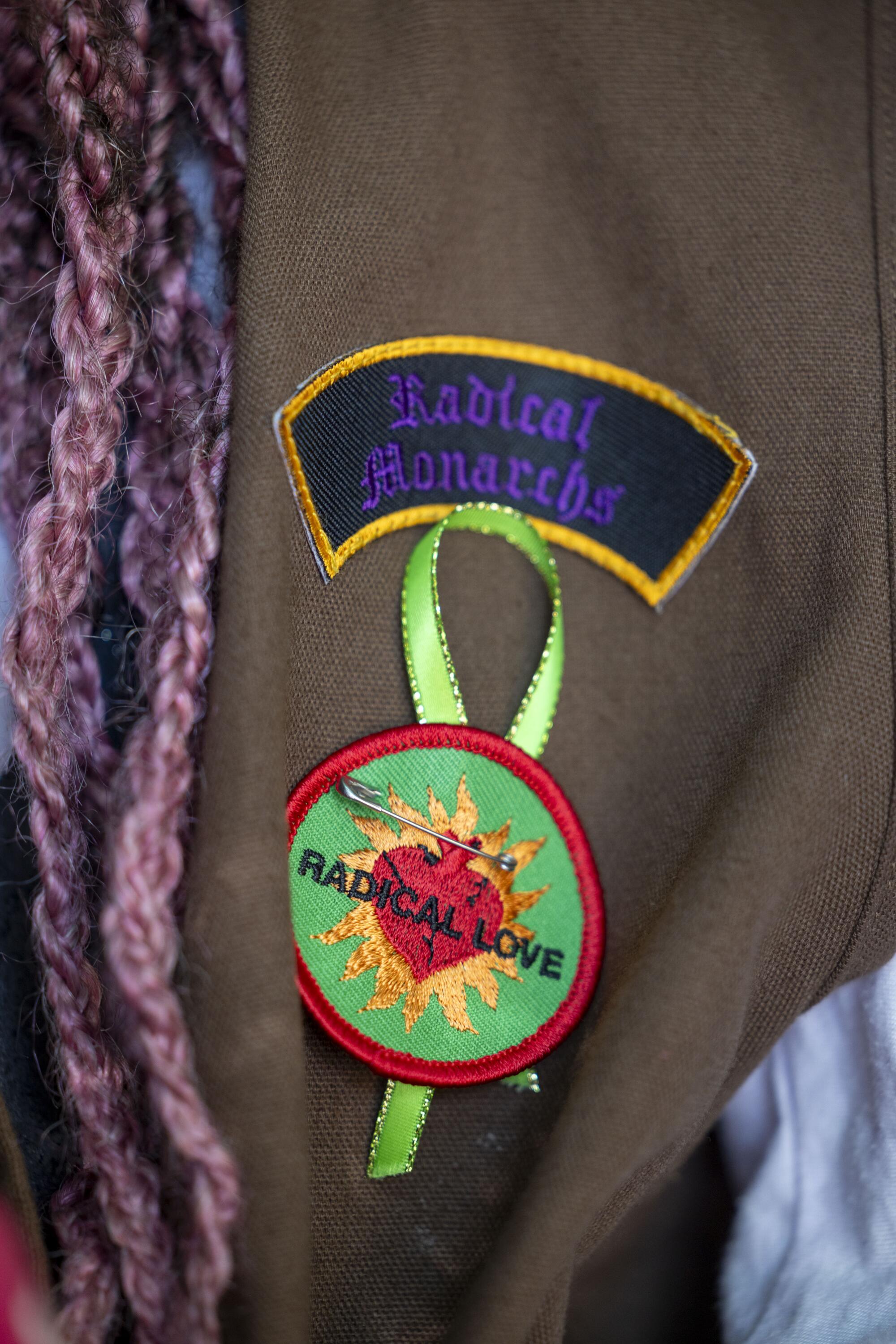 A Radical Love badge and Radical Monarchs patch on Elle Fitch's vest.