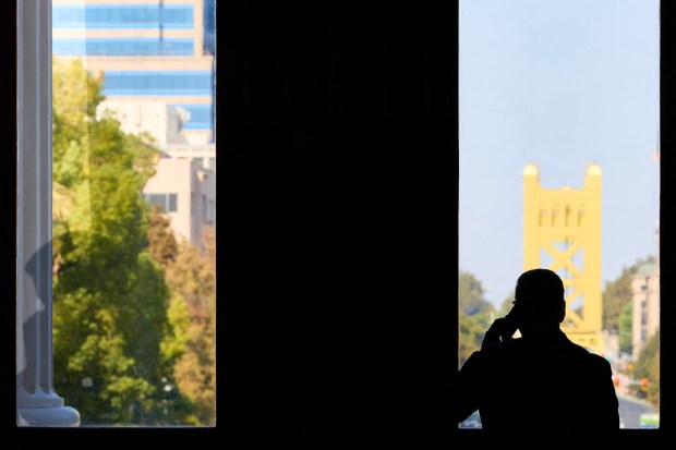 A lobbyist talks on his phone at the state Capitol in Sacramento on Sept. 12, 2025. (Fred Greaves/CalMatters via AP)